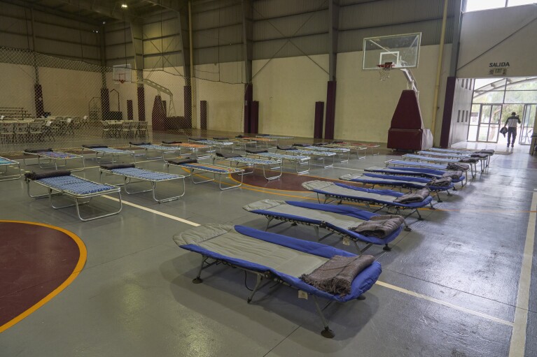Cots are installed in a gym turned into a temporary shelter before the arrival of Hurricane Hilary, in Ensenada, Mexico, Saturday, Aug. 19, 2023. (AP Photo/Alex Cossio)